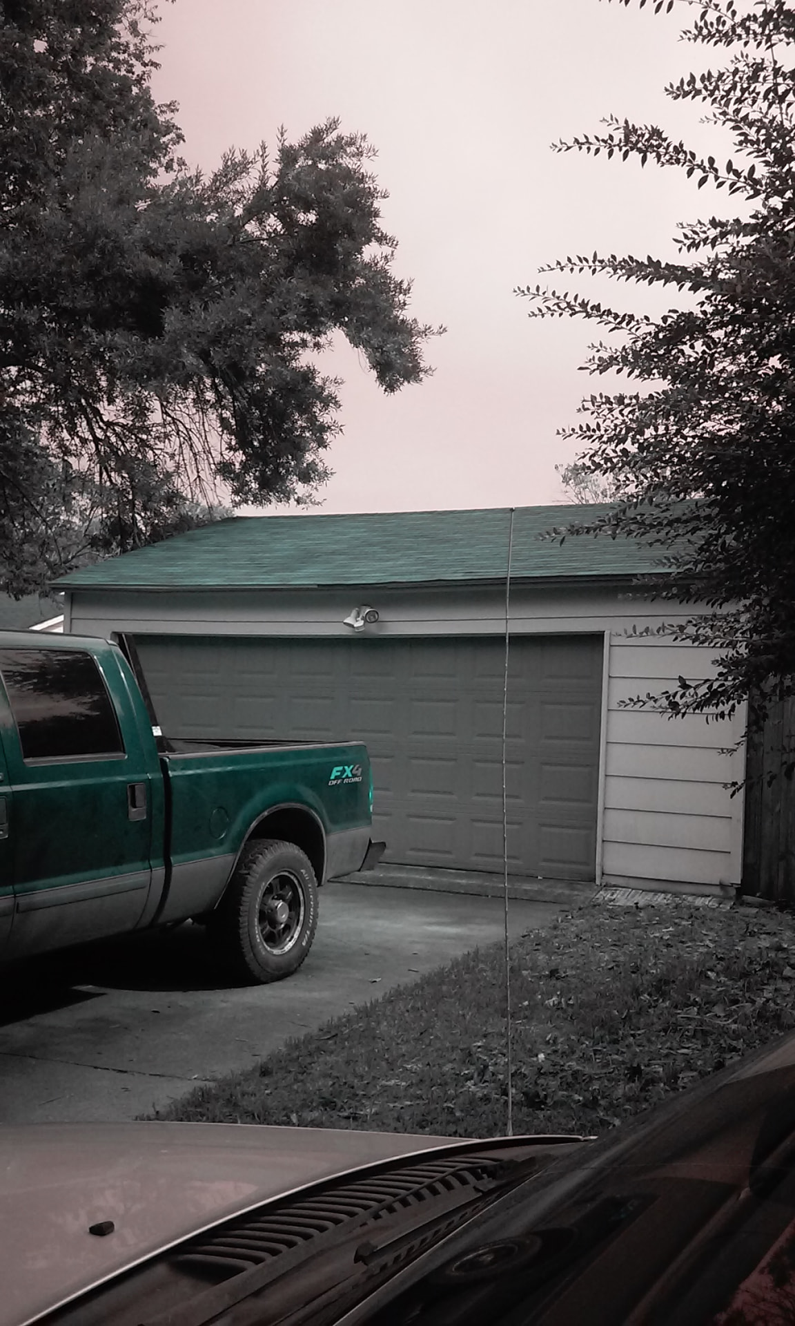 Detached garage roof replacement with the work truck parked in the driveway